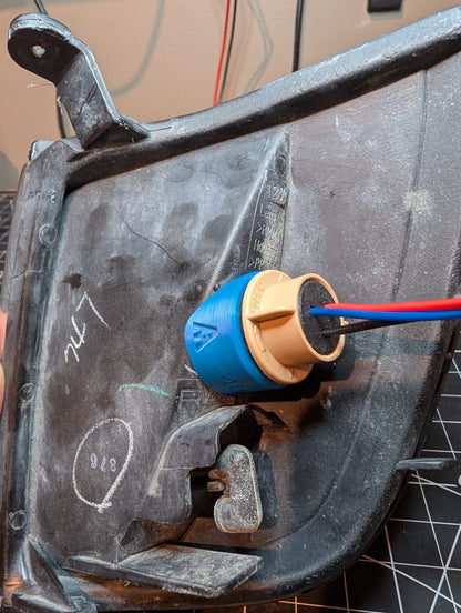 Electrical connector with blue and red wires attached to a metal surface